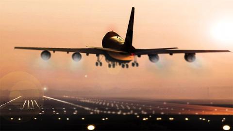 Airplane landing at sunset