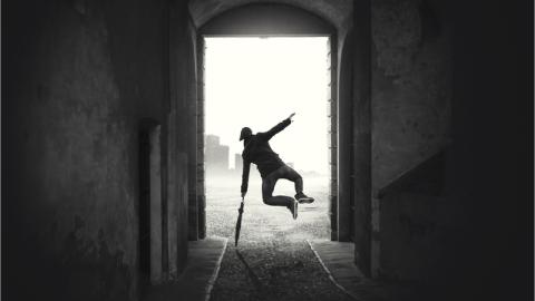 A man jumping with an umbrella