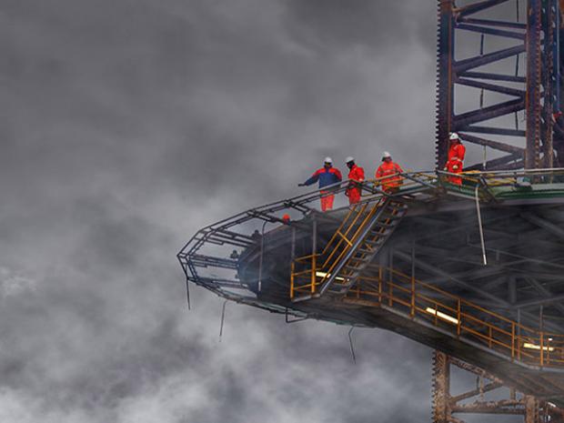 Workers on an elevated deck of a boat