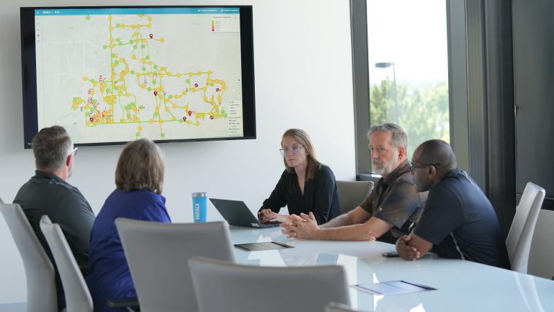 Vaisala staff reviewing data together in a meeting