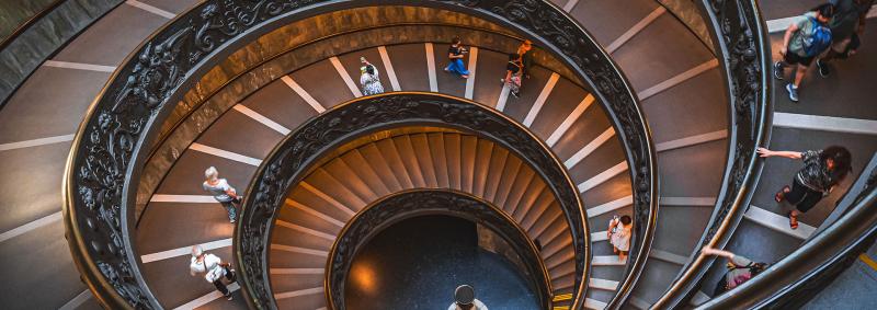 People walking on museum spiral staircase